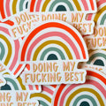 A pile of rsainbow sticker with 'DOING MY FUCKING BEST' written on the bottom.