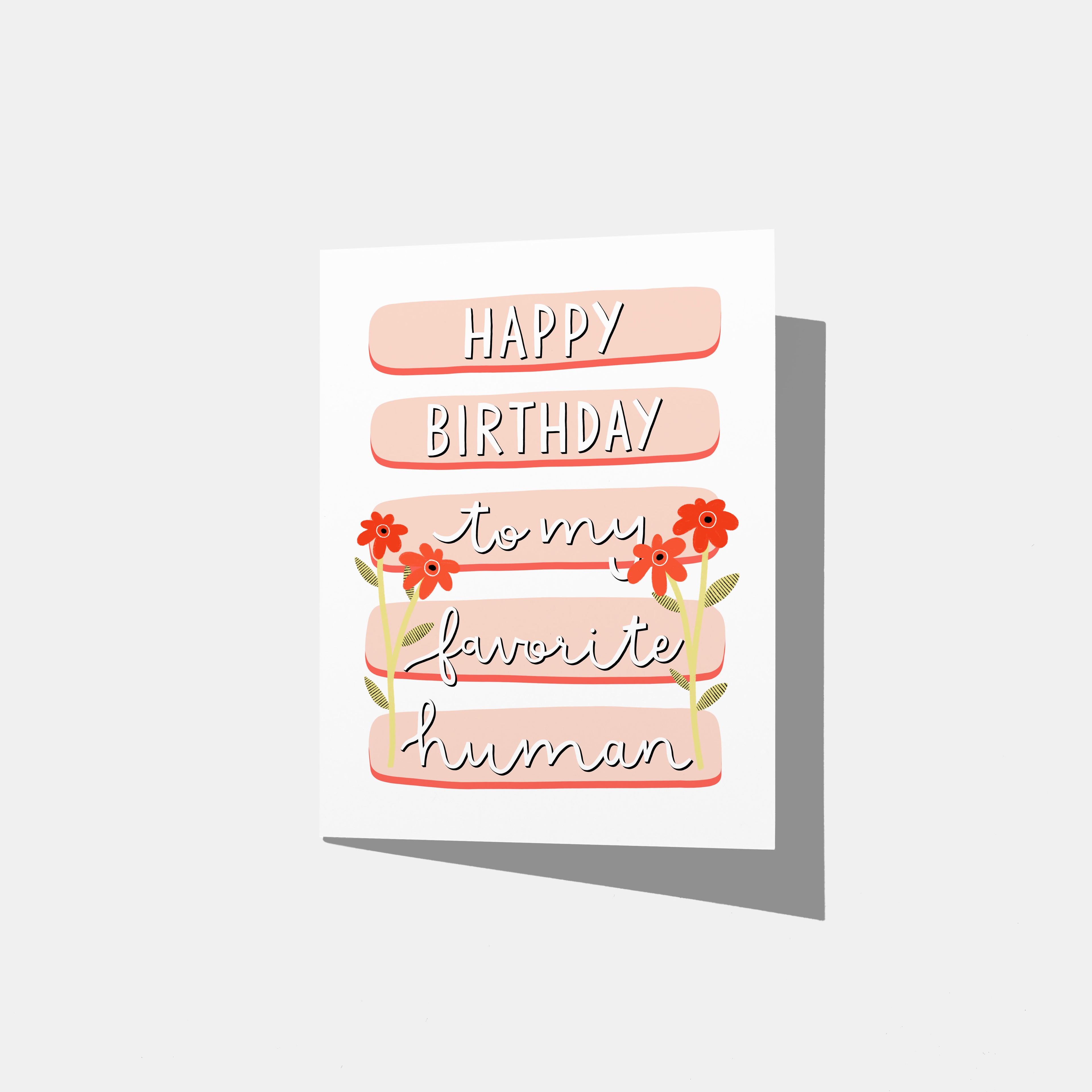 A mockup of a birthday card with the text 'HAPPY BIRTHDAY to my favorite human' in stylized lettering, on a background of peach-colored horizontal bards, decorated with red flowers.