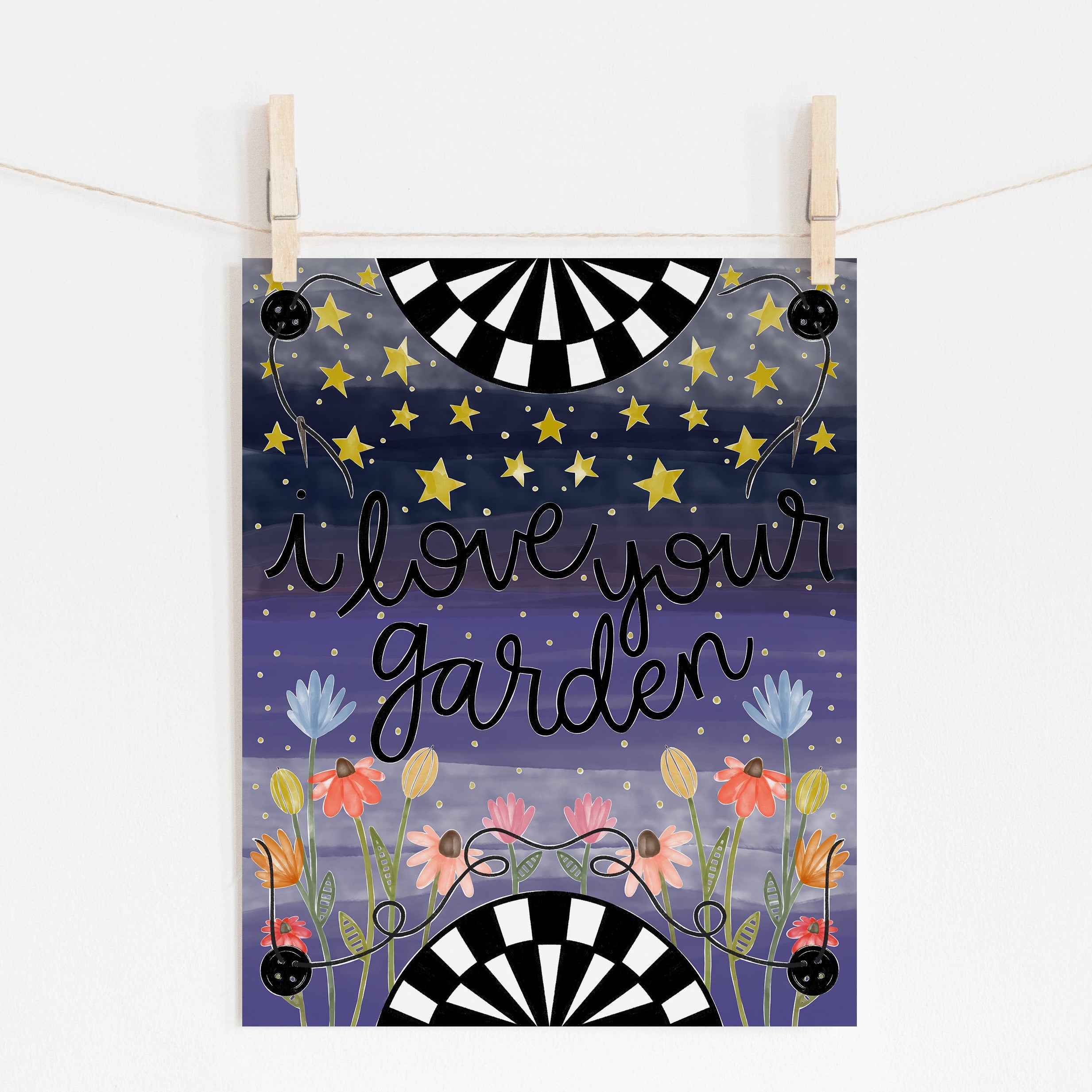 An 8x10 art print that says 'i love your garden' on a background of shades of blue with flowers at the bottom and stars at the top. The top and bottom have black and white half circles and there are buttons in each corner of the print with a needle on string.