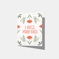 A mockup of a greeting card with floral design and text 'I MISS YOUR FACE' on a white background.