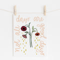 An 8x10 art print that says 'not all days are good days' from the bottom left side, around the print, to the bottom right side. The center re drooping flowers with tears dropping from them.