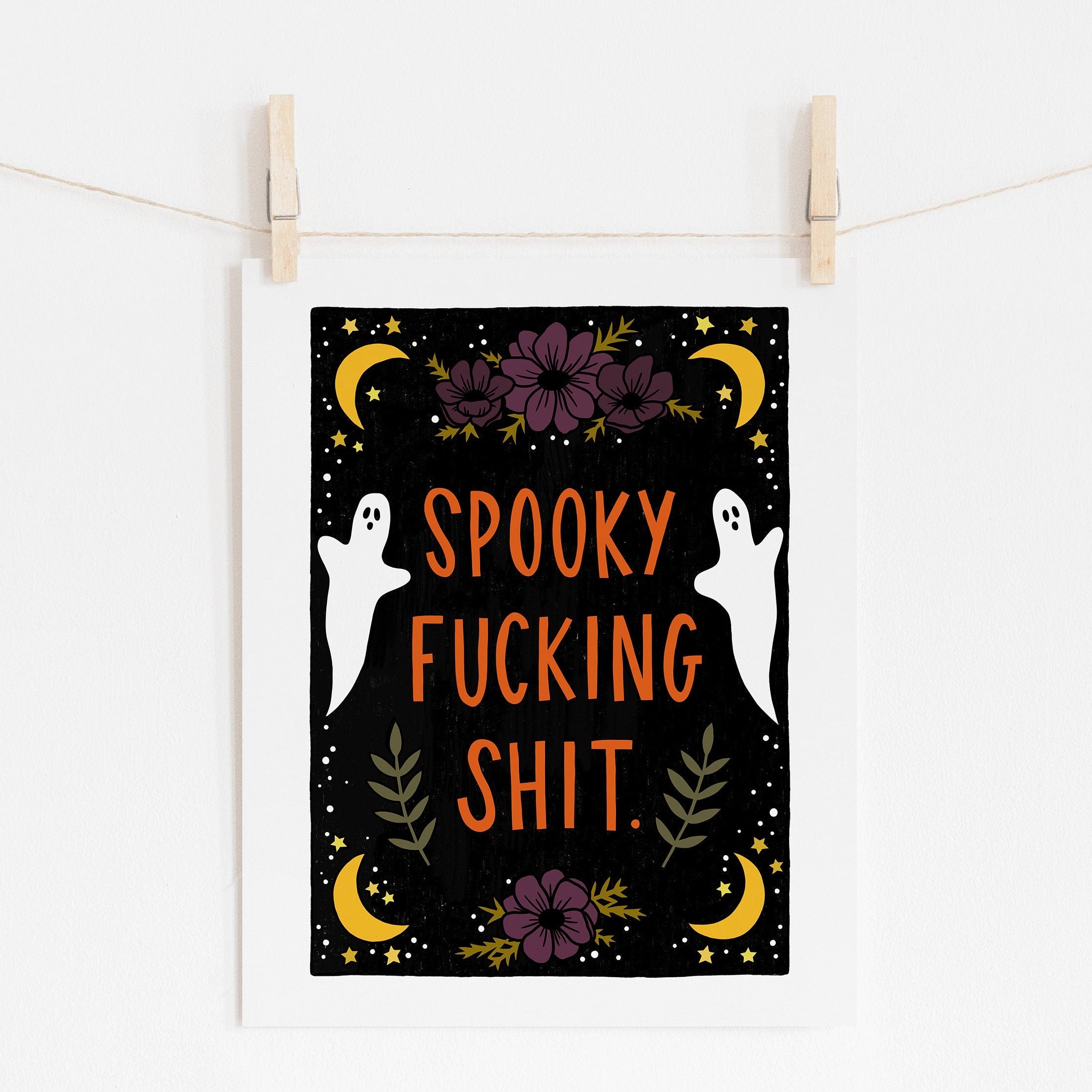 8x10 art print that says 'spooky fucking shit.' in orange, surrounded by purple flowers, white ghosts, and yellow moons and stars on a black background.