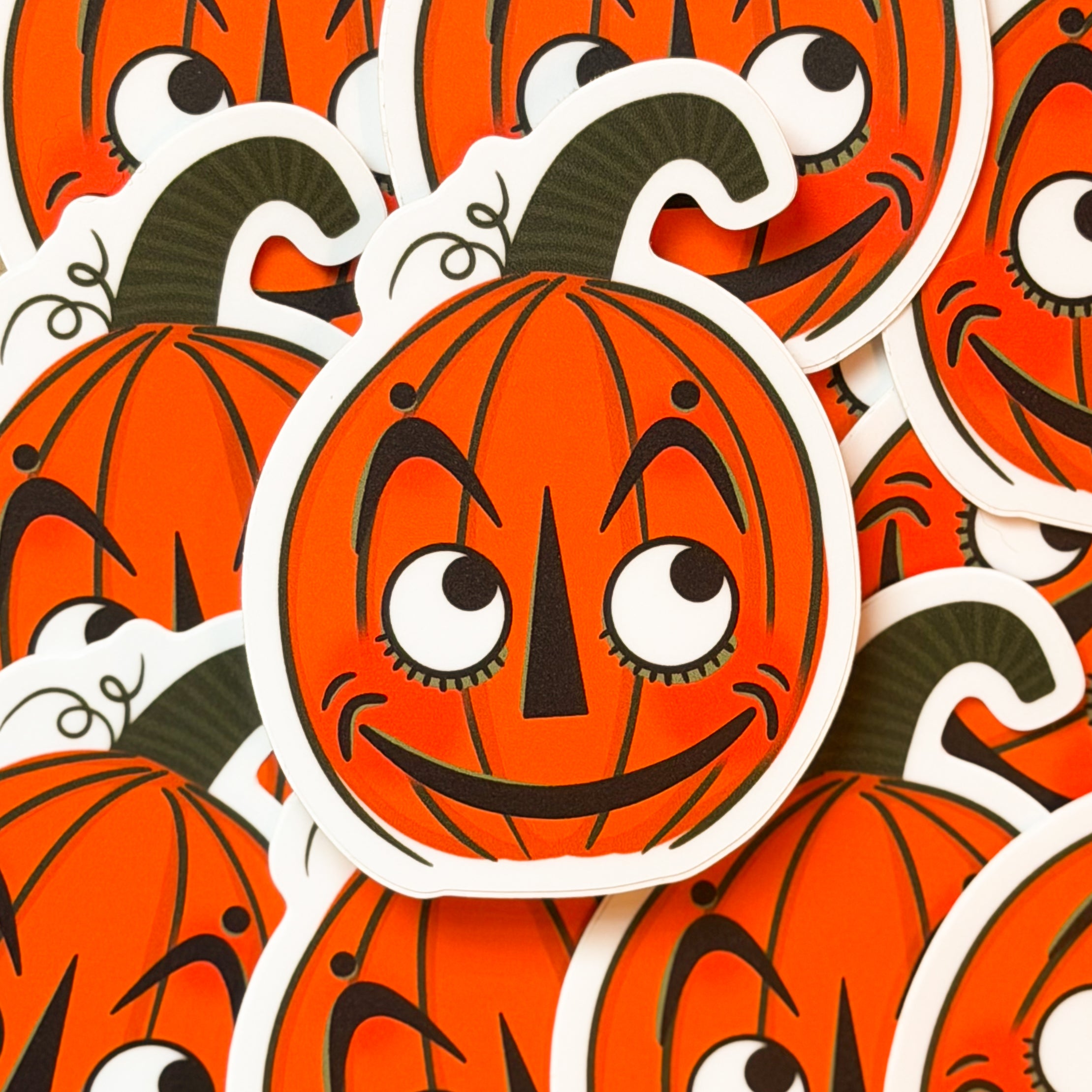 A vintage halloween pumpkin sticker with a cute face.