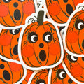 A vintage halloween pumpkin sticker with a cute face.