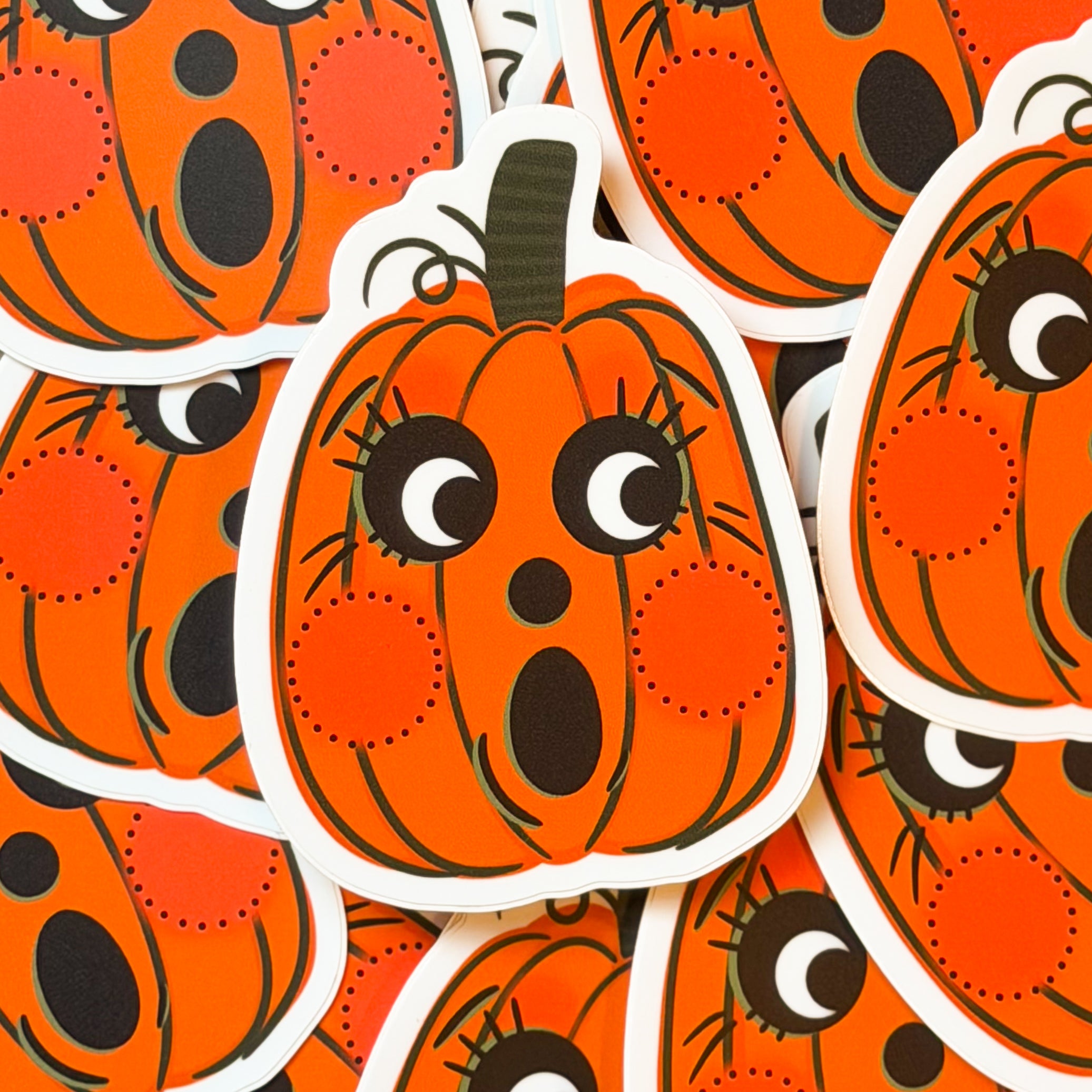 A vintage halloween pumpkin sticker with a cute face.