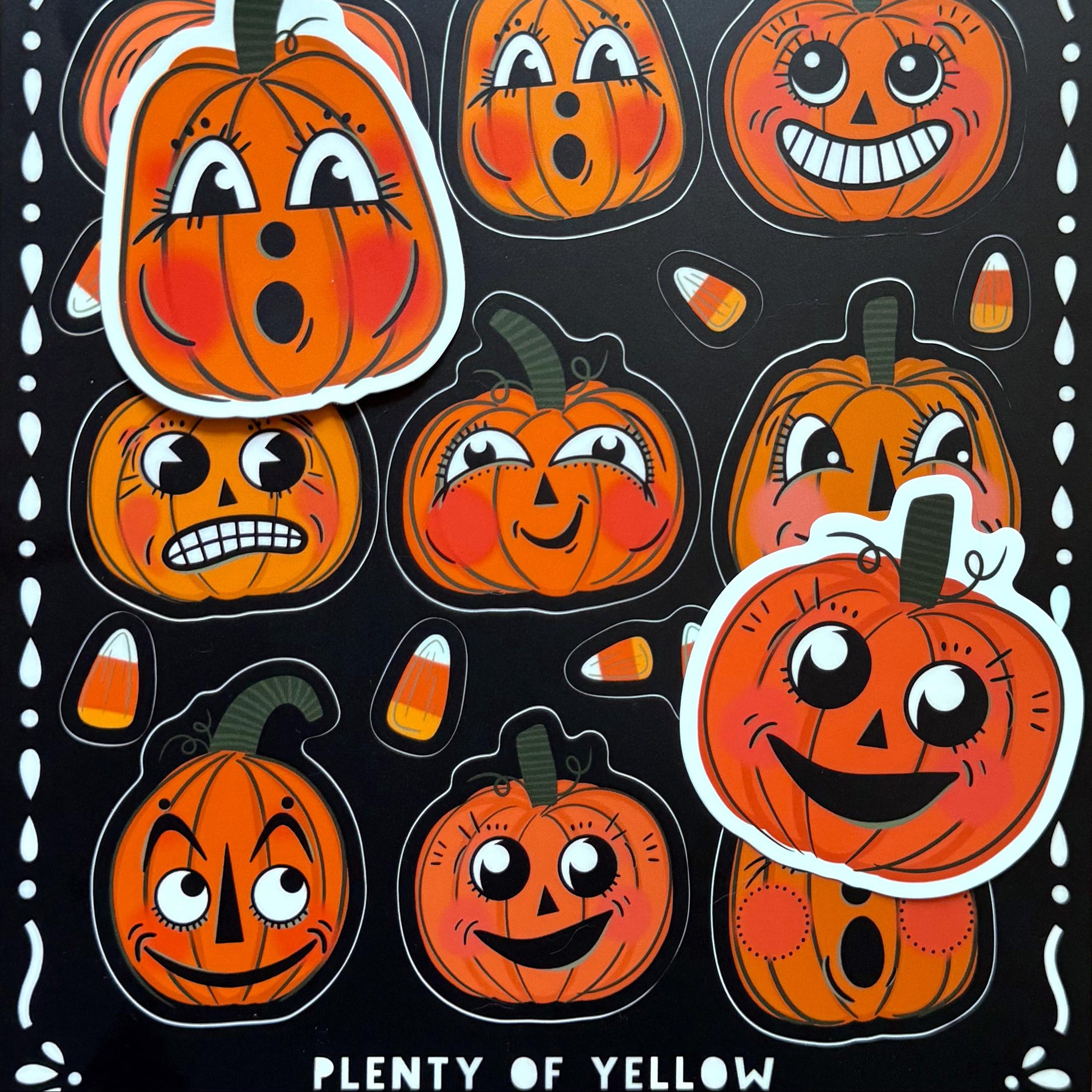 Two single vintage pumpkin stickers sitting on top of a vintage pumpkin sticker sheet.