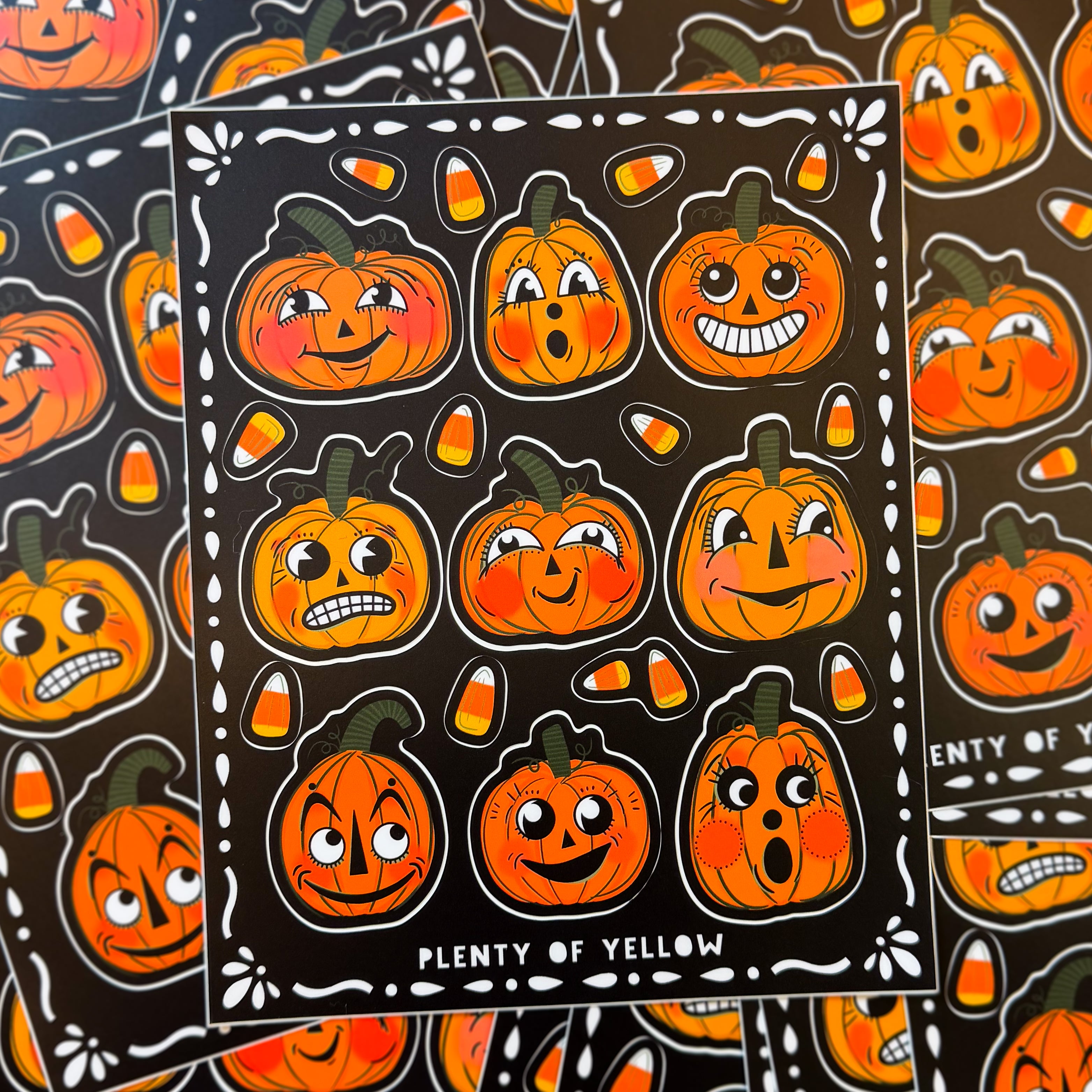 A pile of sticker sheets with vintage pumpkins and candy corn on them.
