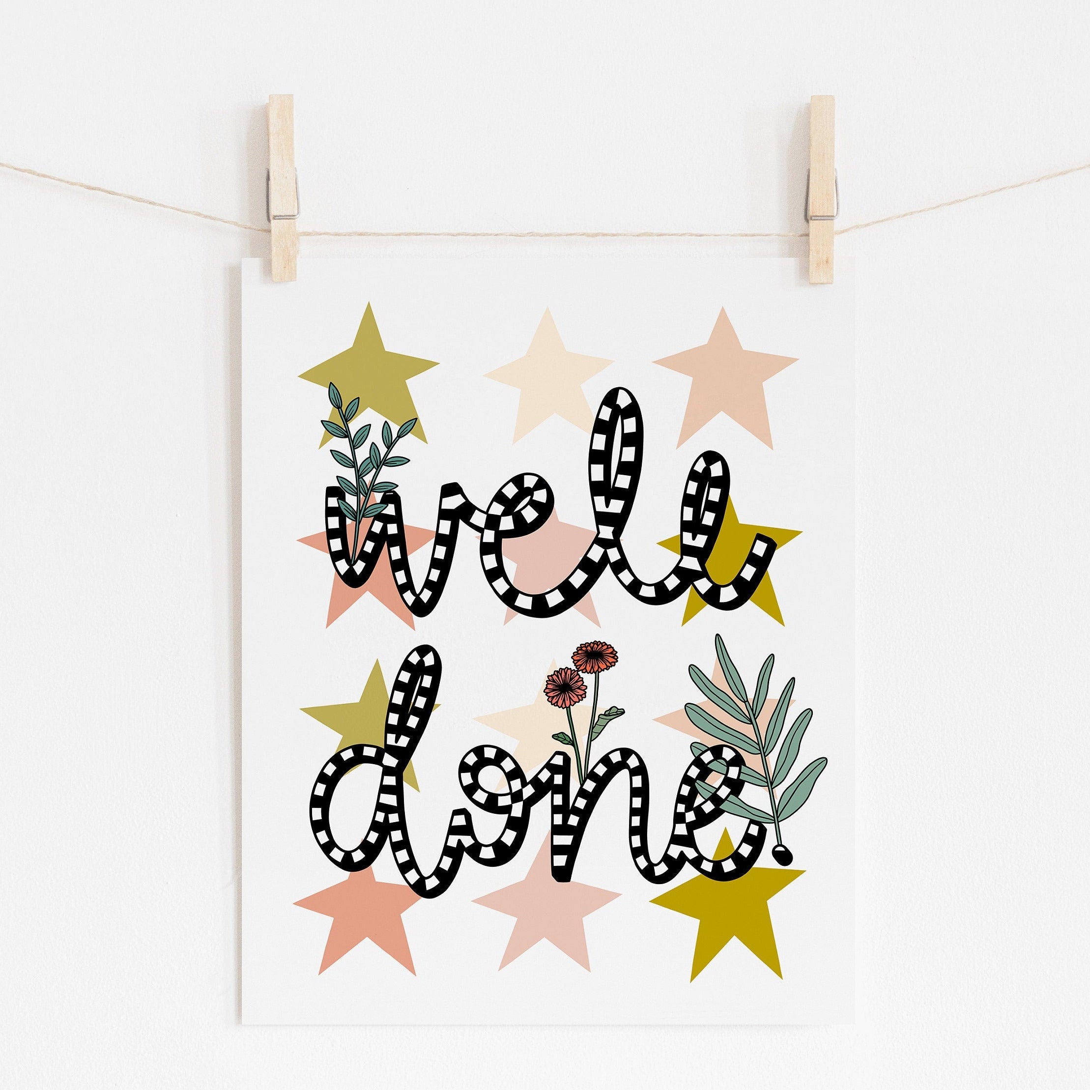 An 8x10 art print that says 'well done' in black and white with flowers and stars printed in the background.