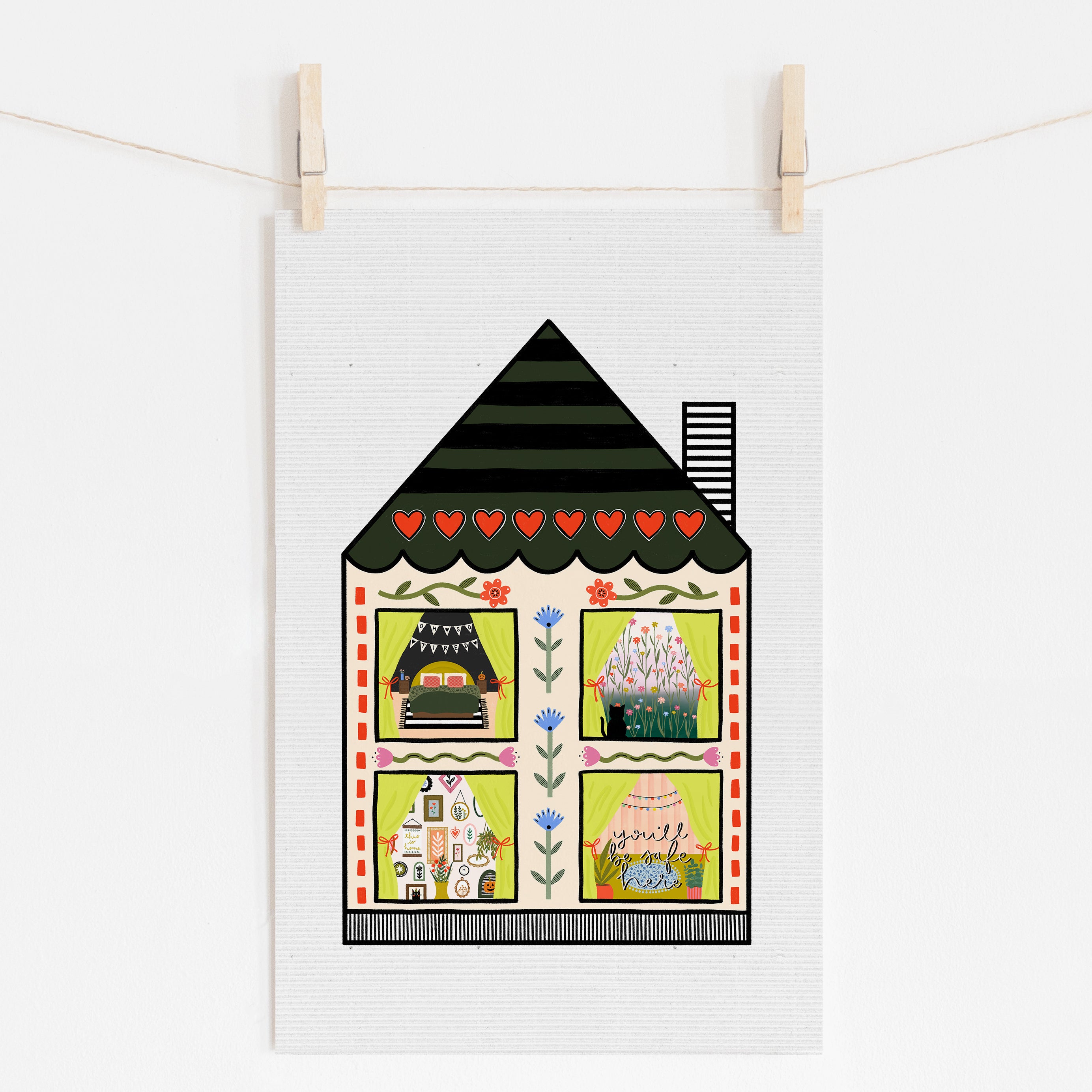 An 11x17 art print of a house that shows a different scene in each window. The bottom one has text that says 'you'll be safe here'.