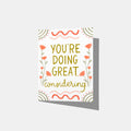 A mockup of a greeting card that says 'YOU'RE DOING GREAT, considering.' in the middle surrounded by flowers and lines and embellishments.