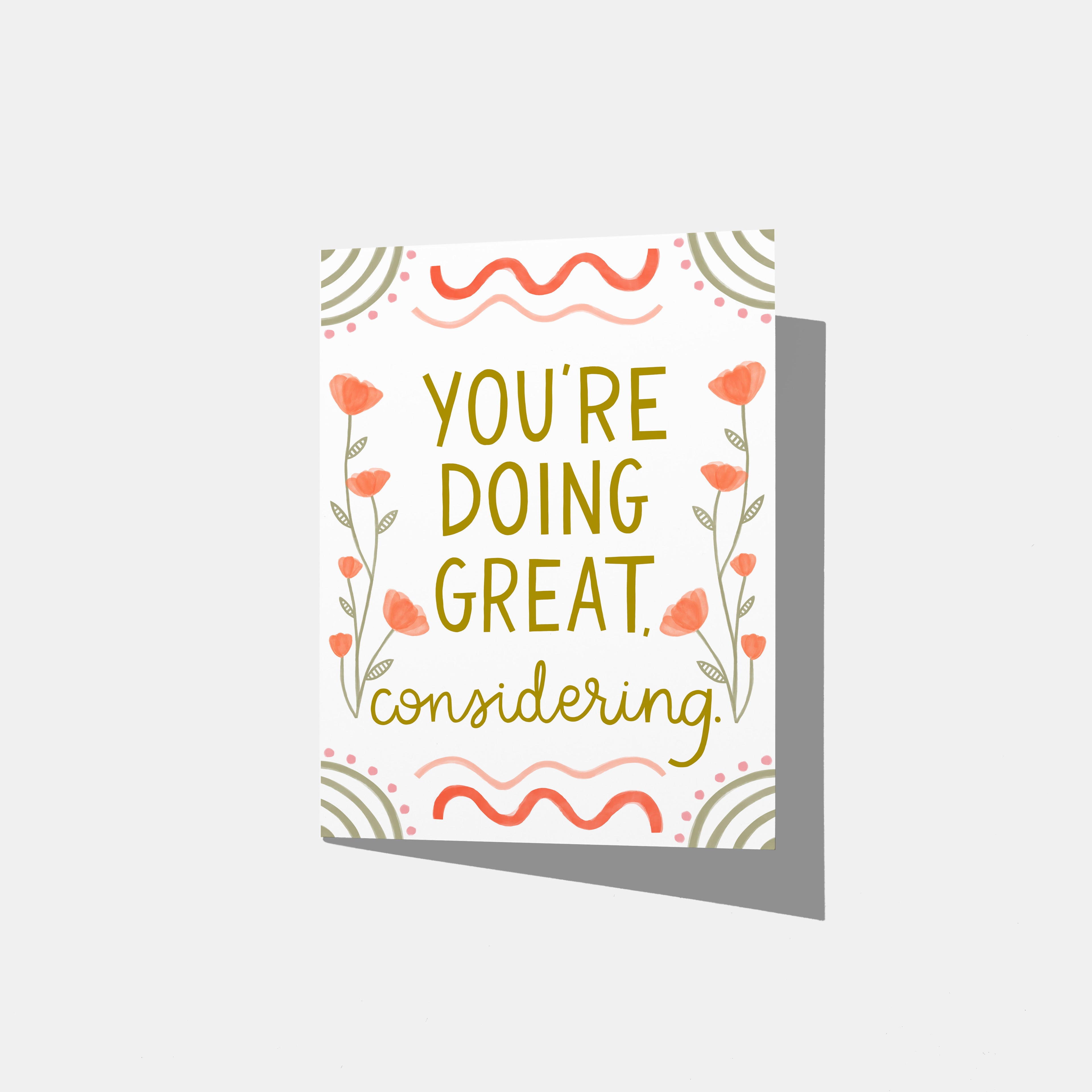 A mockup of a greeting card that says 'YOU'RE DOING GREAT, considering.' in the middle surrounded by flowers and lines and embellishments.
